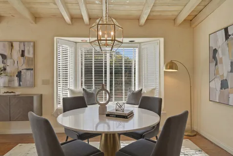 a view of a dining room with furniture and window