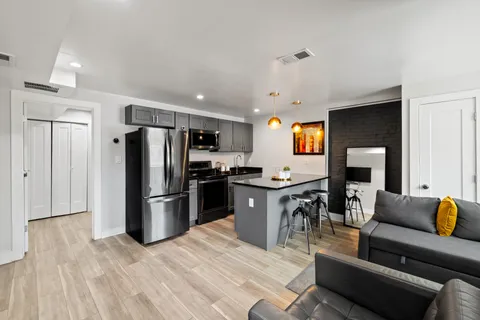 a kitchen with stainless steel appliances granite countertop a refrigerator stove top oven and sink