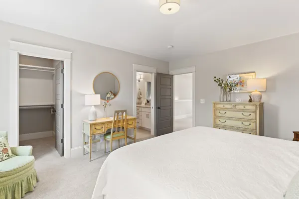 a bedroom with a bed a table and chair