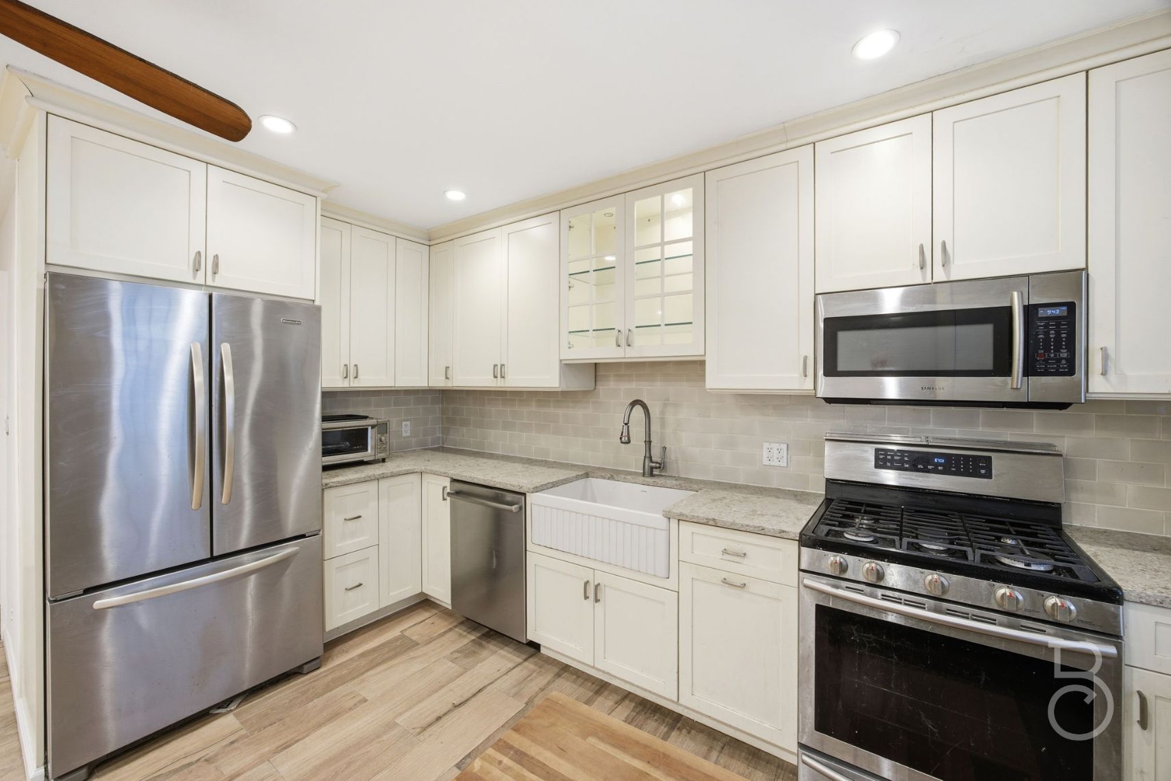 22-61 46th Street Queens, NY 11105 - Photo 5 of 24 a kitchen with stainless steel appliances a stove a sink and a microwave