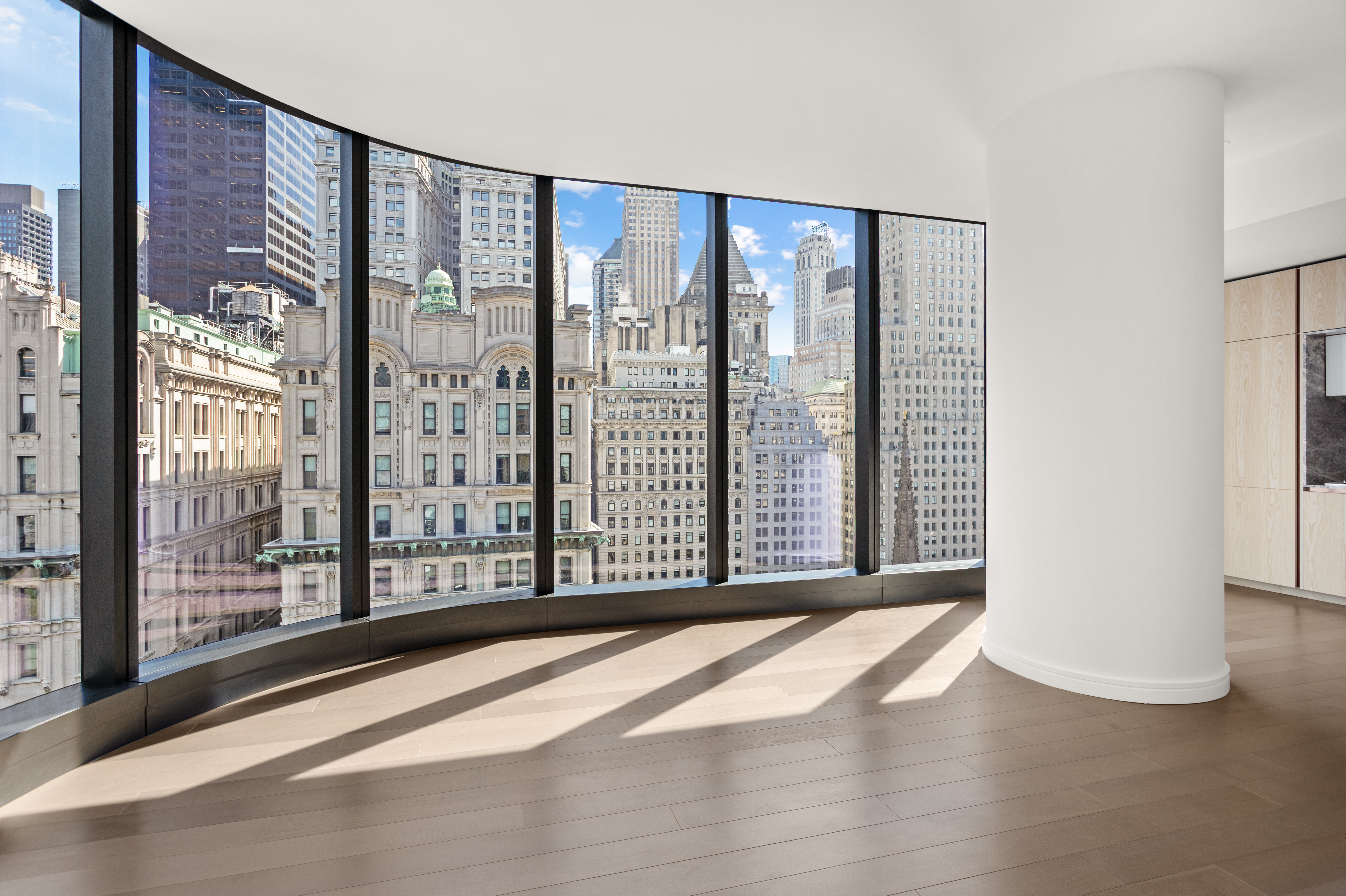 125 Greenwich Street, Unit 31A Manhattan, NY 10006 - Photo 6 of 23 a view of an empty room with wooden floor and a window