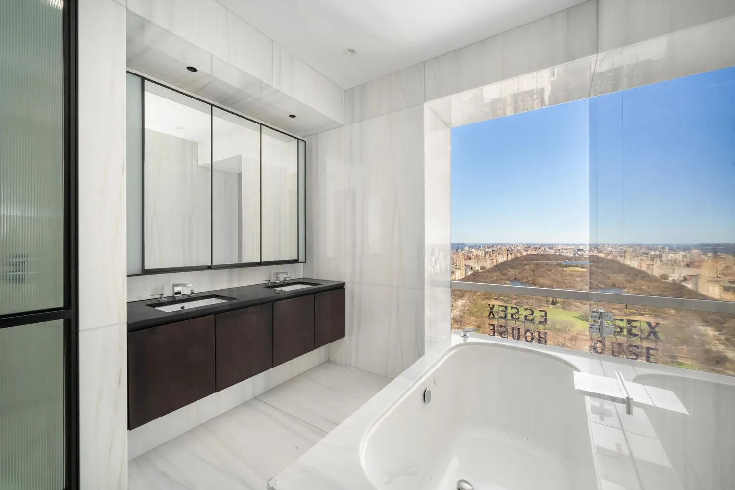 a bedroom with a bed and glass window