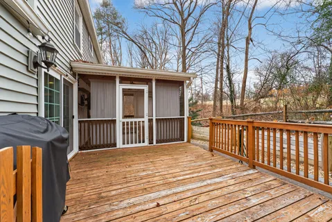 a view of a house with a wooden deck
