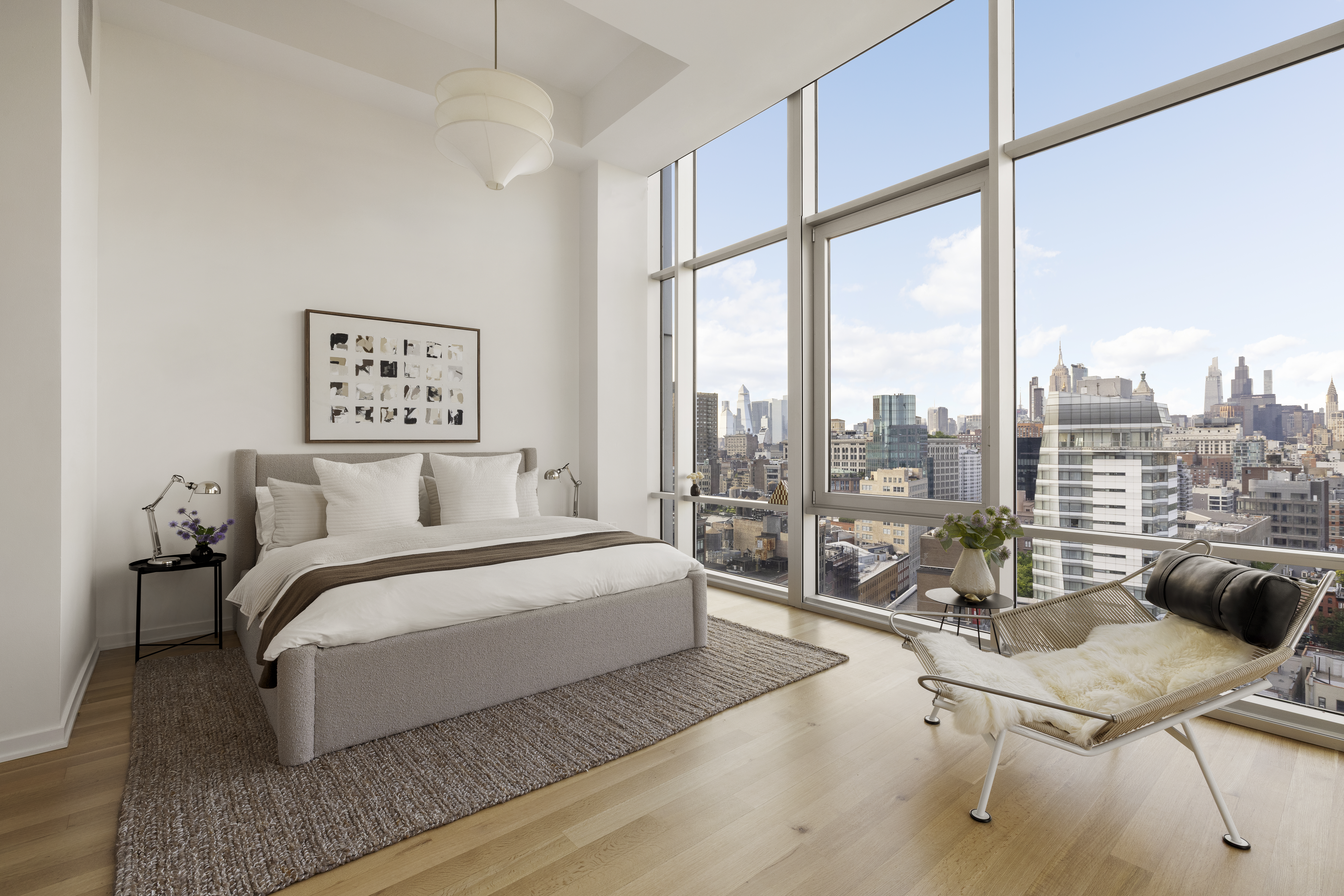 52 East 4th Street, Unit PH3 Manhattan, NY 10003 - Photo 10 of 22 a spacious bedroom with a bed and a large window
