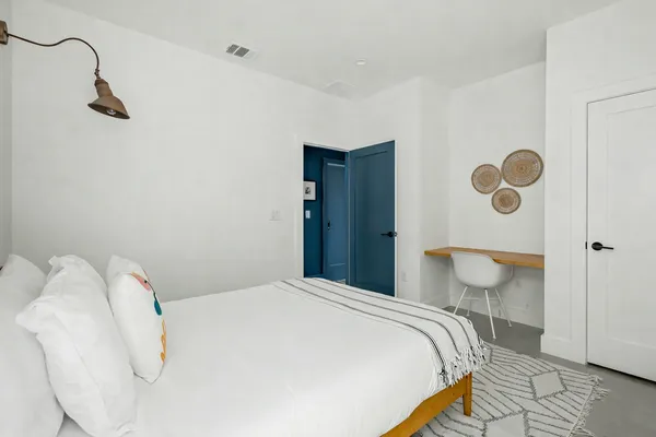 a bedroom with a bed and lamp