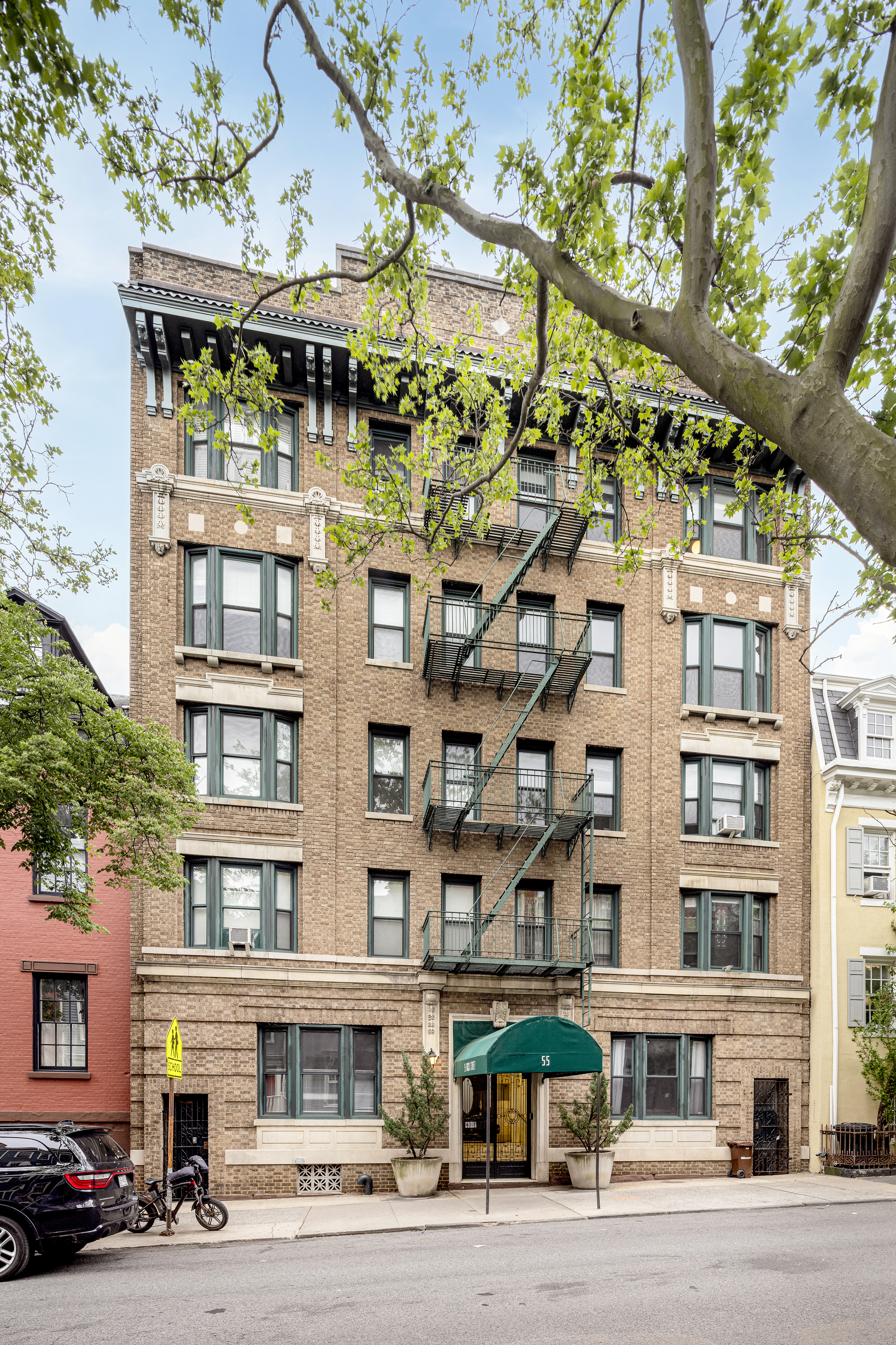 55 Hicks Street, Unit 2 Brooklyn, NY 11201 - Photo 7 of 8 a front view of a building with lot of cars and trees