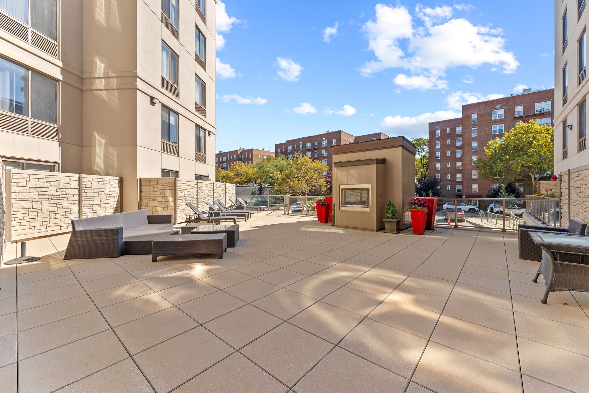 64-05 Yellowstone Boulevard, Unit 414 Queens, NY 11375 - Photo 12 of 14 a view of a patio with dining table and chairs with an umbrella