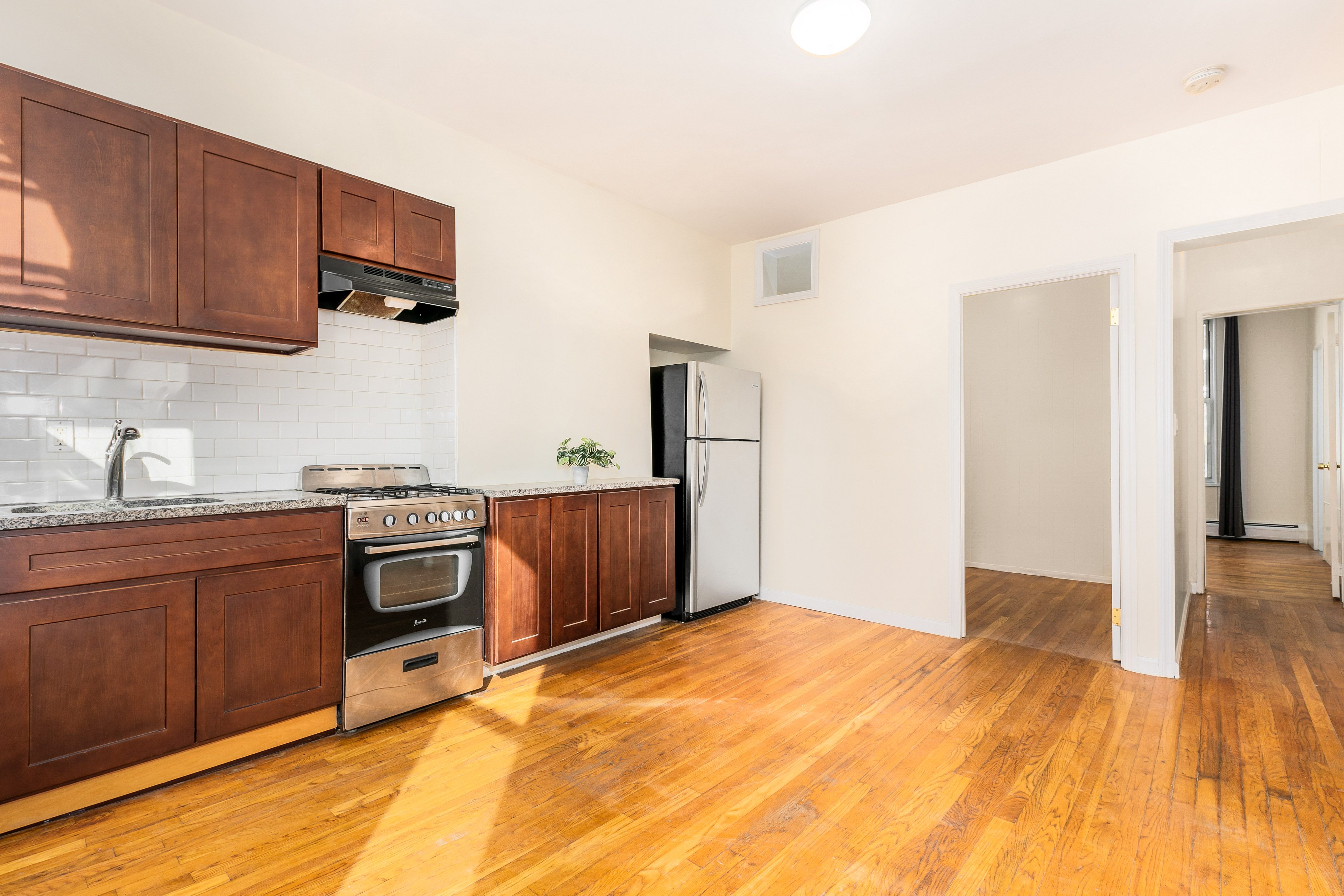 148 29th Street Brooklyn, NY 11232 - Photo 12 of 31 a bedroom with a bed and wooden cabinets