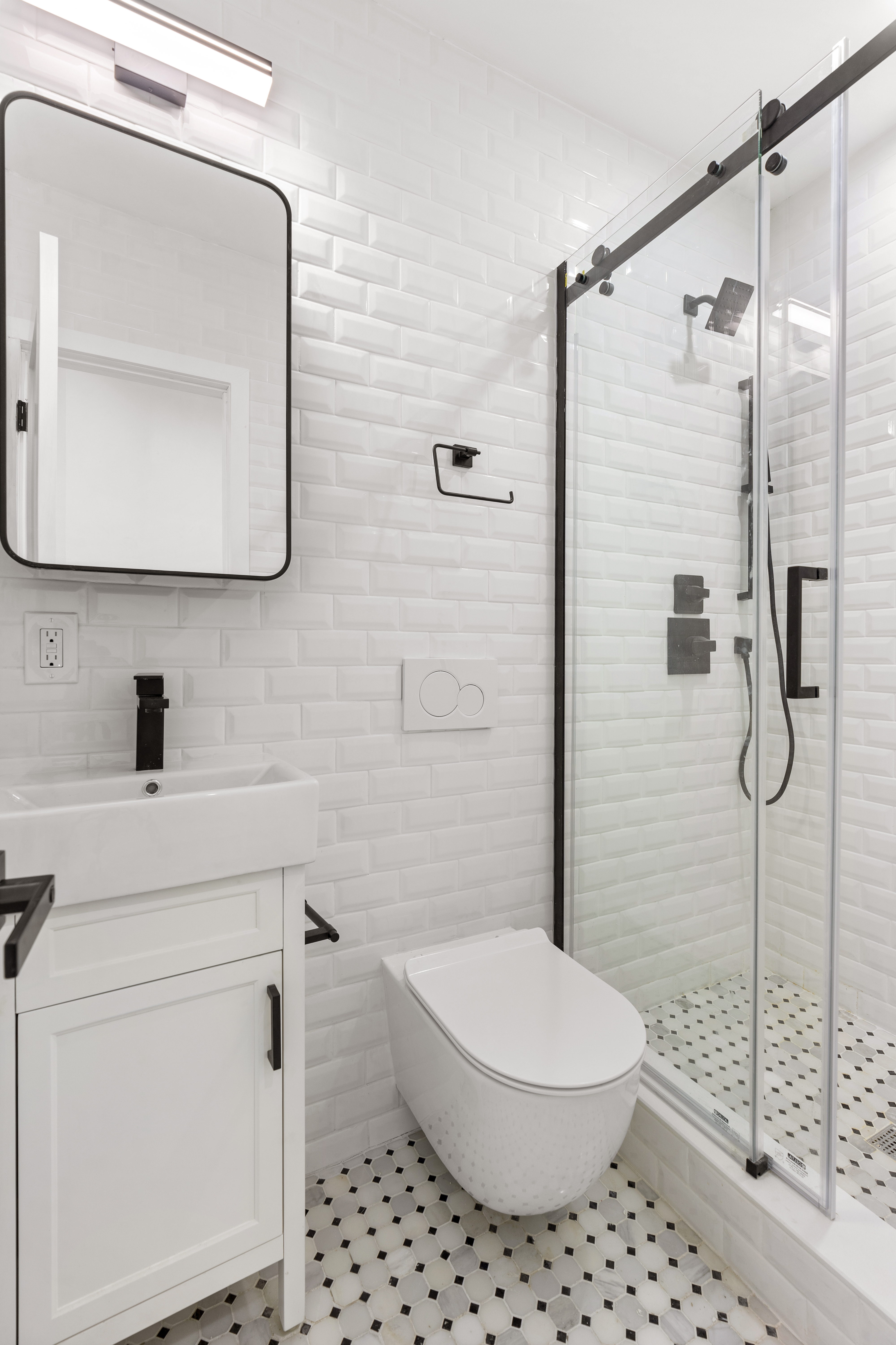 714 Greenwich Street, Unit 8 Manhattan, NY 10014 - Photo 6 of 7 a bathroom with a toilet a sink and a mirror