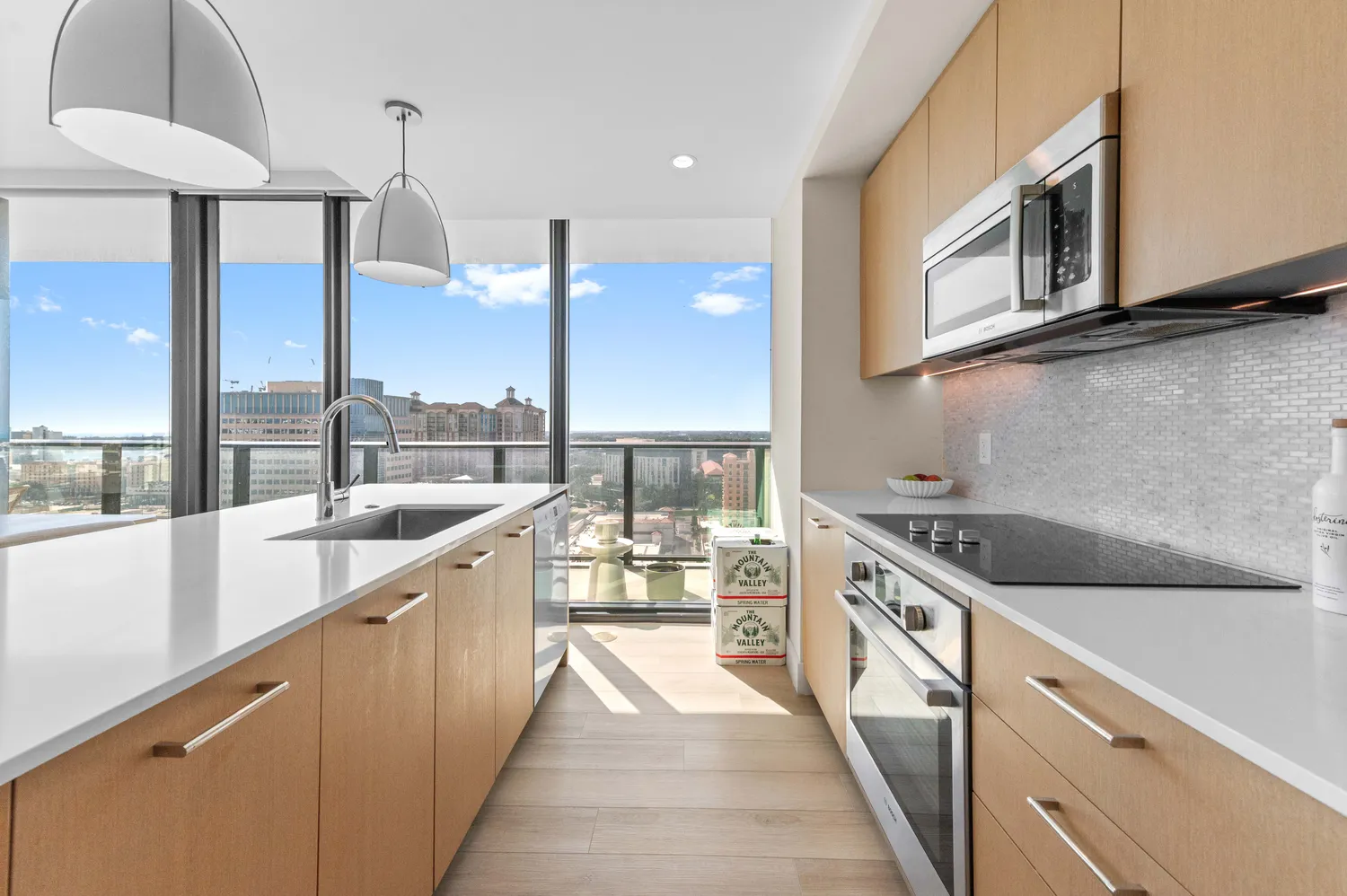 a kitchen with stainless steel appliances granite countertop a sink and a stove