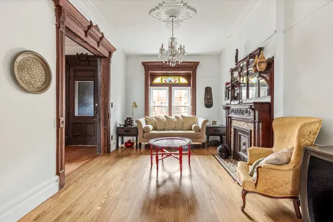 a view of a livingroom with furniture window and wooden floor