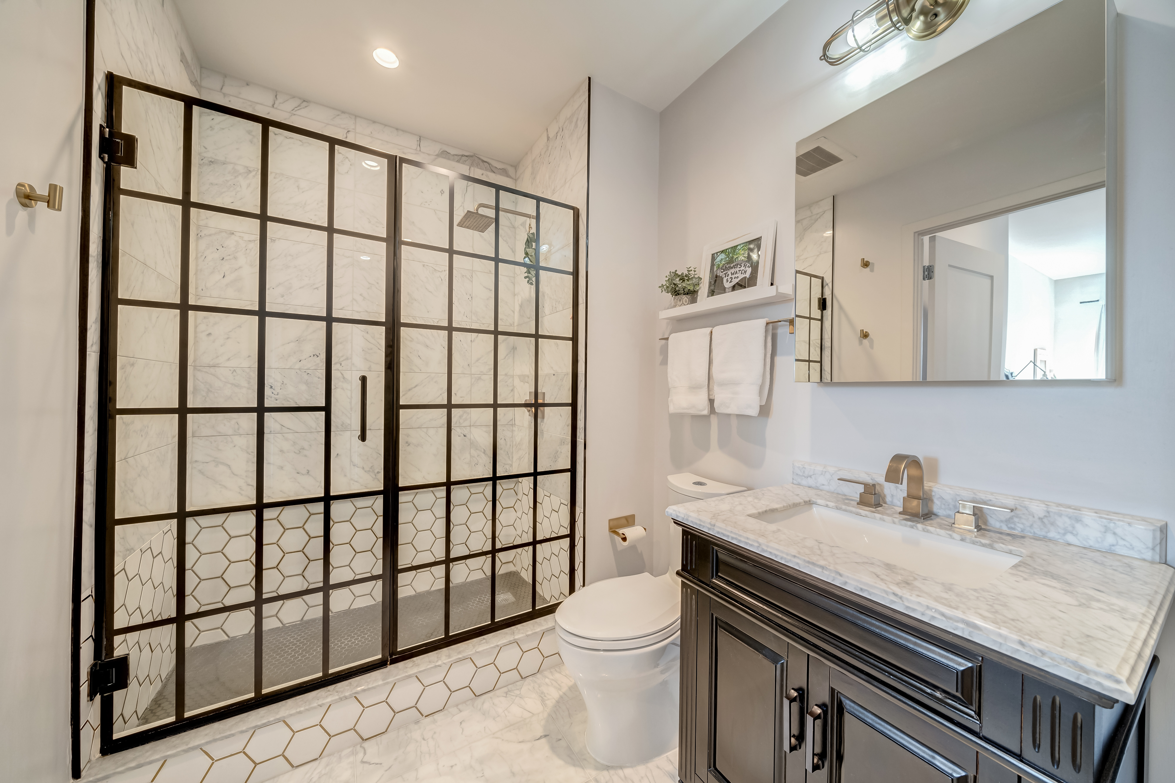 45 Sutton Square Southwest, Unit PH10 Washington, DC 20024 - Photo 28 of 44 a bathroom with a sink a toilet and a shower curtain