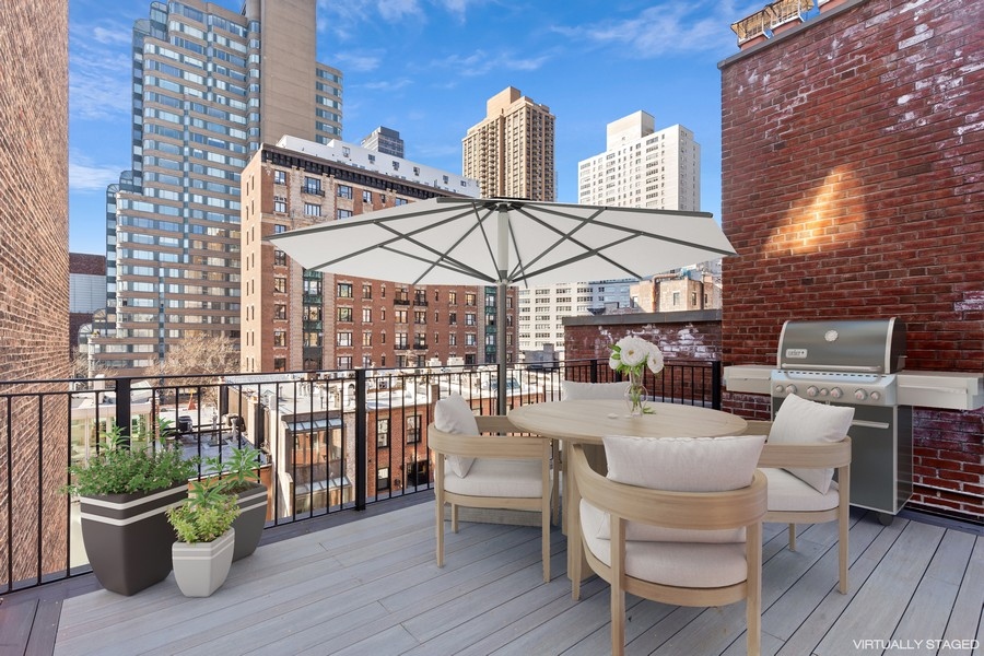 128 West 70th Street, Unit 10 Manhattan, NY 10023 - Photo 1 of 15 a view of a patio with a dining table and chairs with wooden floor