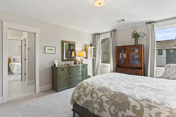 a bedroom with a large bed and a dresser