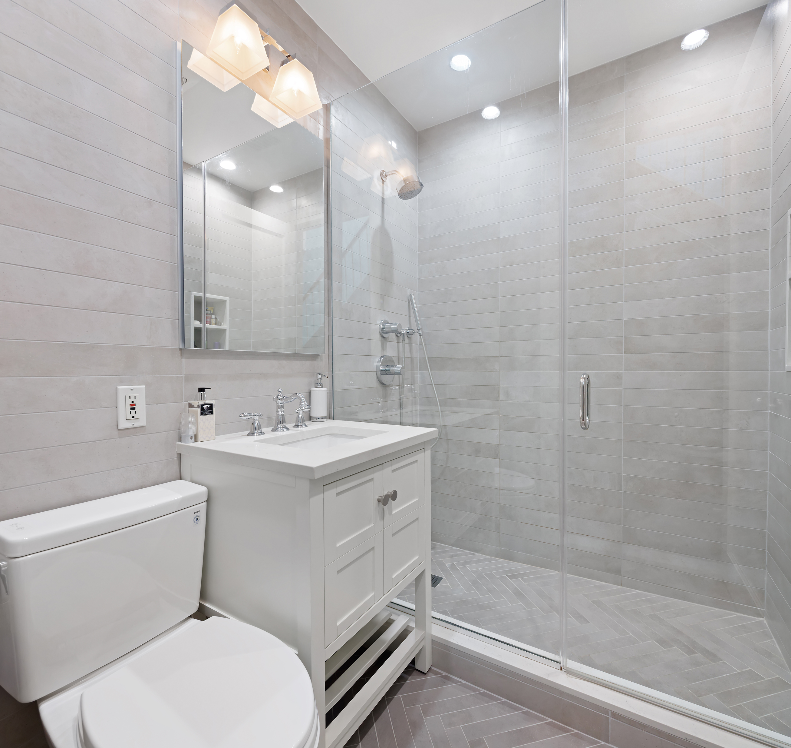 217 West 22nd Street Manhattan, NY 10011 - Photo 10 of 16 a bathroom with a sink toilet vanity and shower