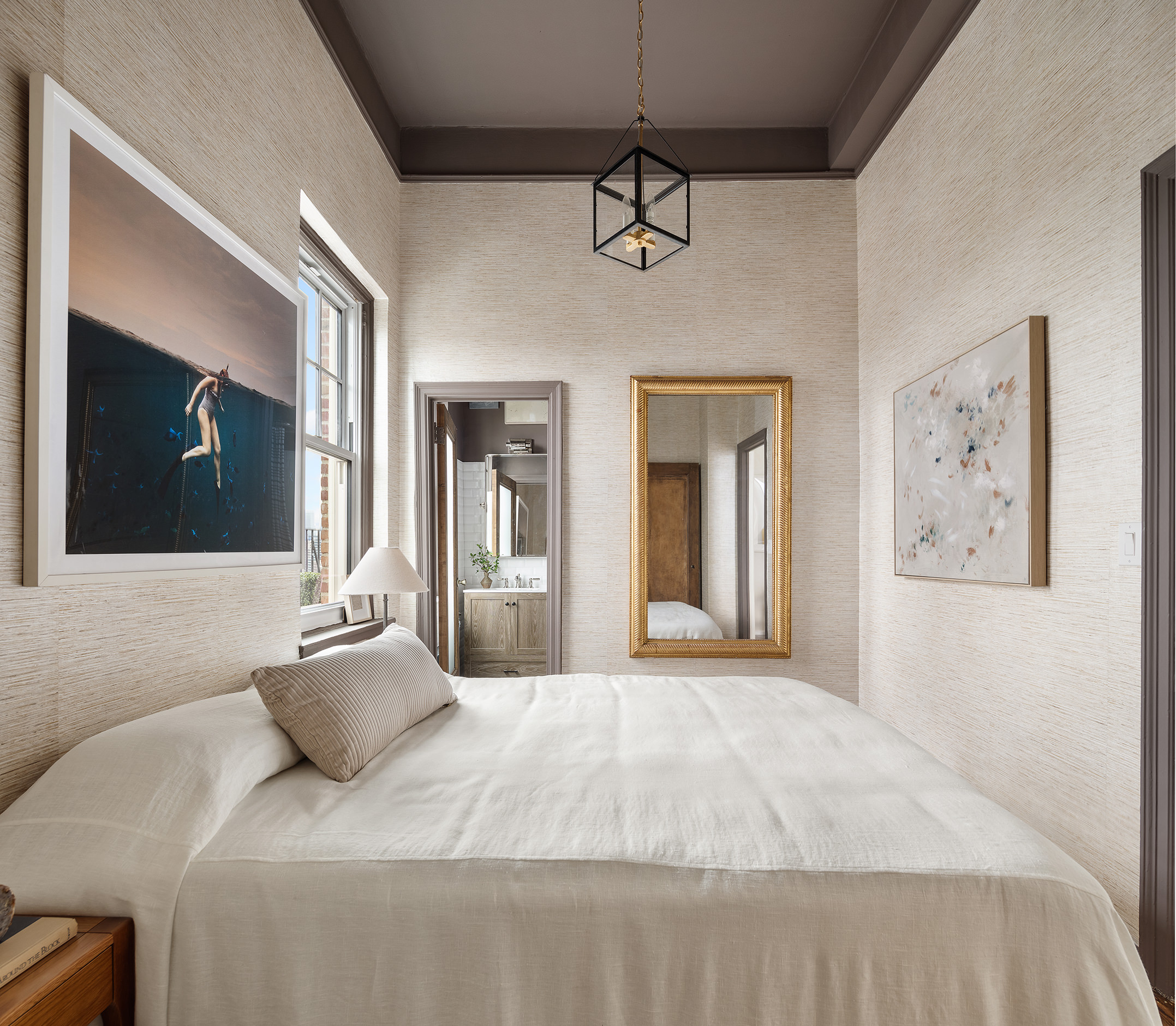 302 West 12th Street, Unit PHE Manhattan, NY 10014 - Photo 12 of 16 a bedroom with a large bed and a chandelier