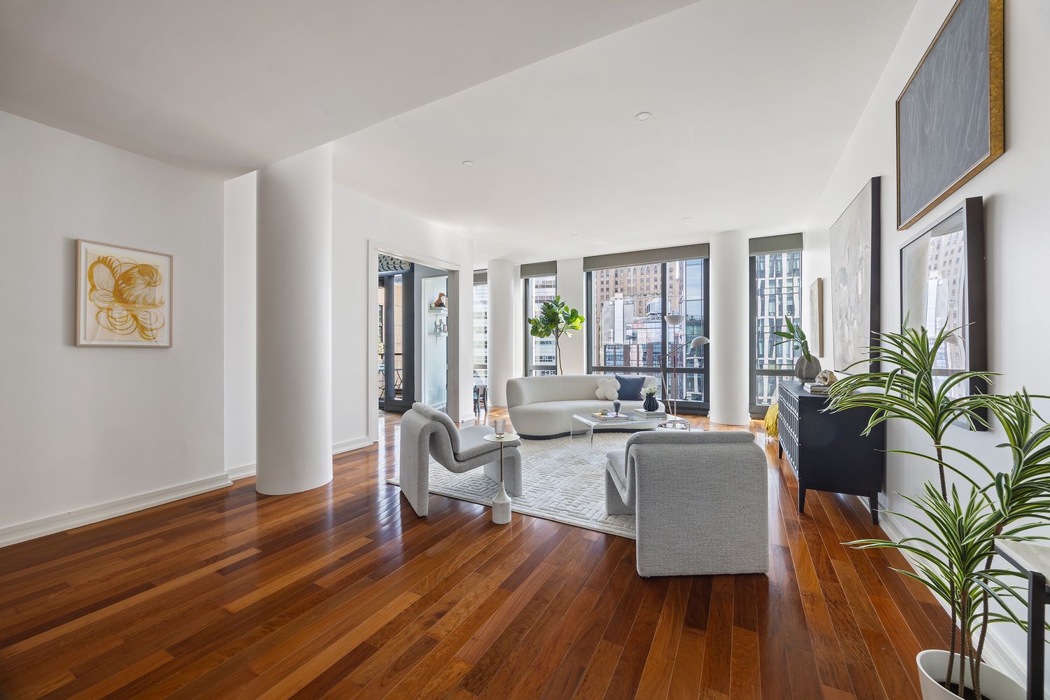 a living room with furniture and wooden floor