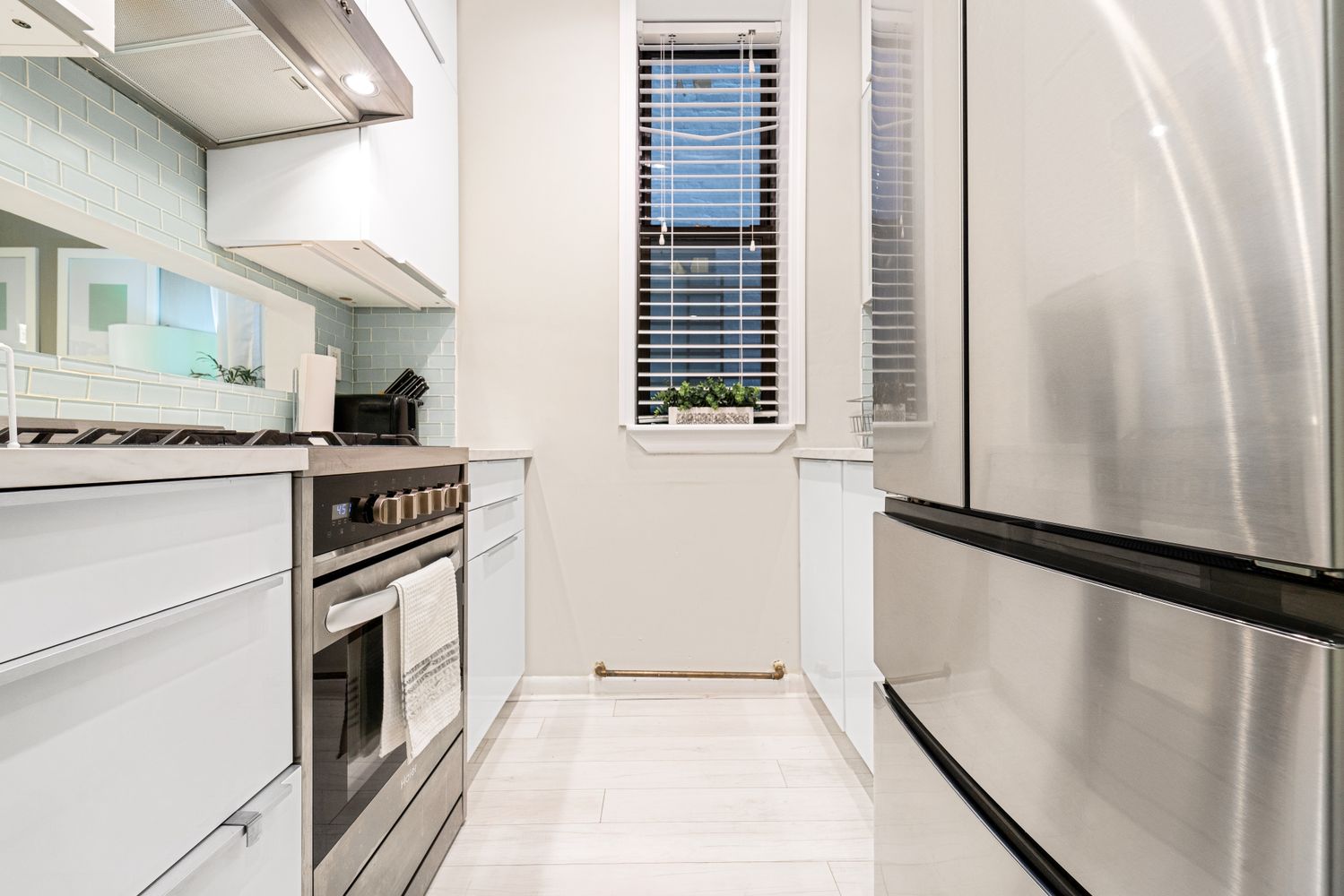 a kitchen with a stove cabinets and a refrigerator