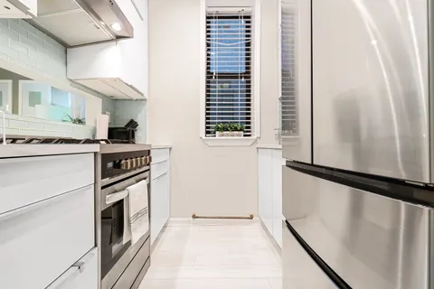 a kitchen with a stove cabinets and a refrigerator