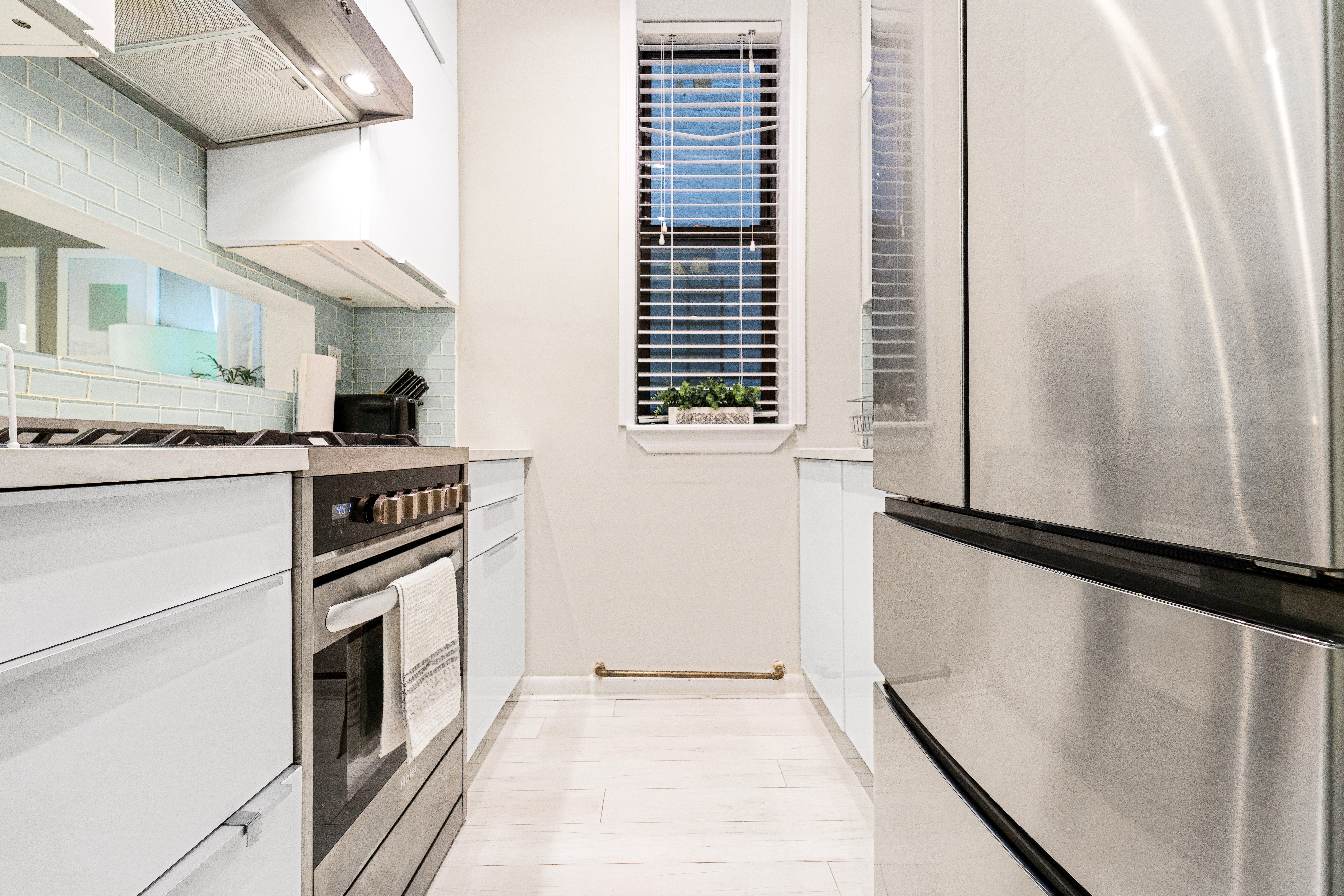 108 West 114th Street, Unit 4B Manhattan, NY 10026 - Photo 4 of 9 a kitchen with a stove cabinets and a refrigerator