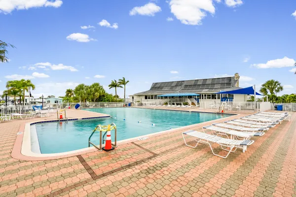a park with water view and palm trees