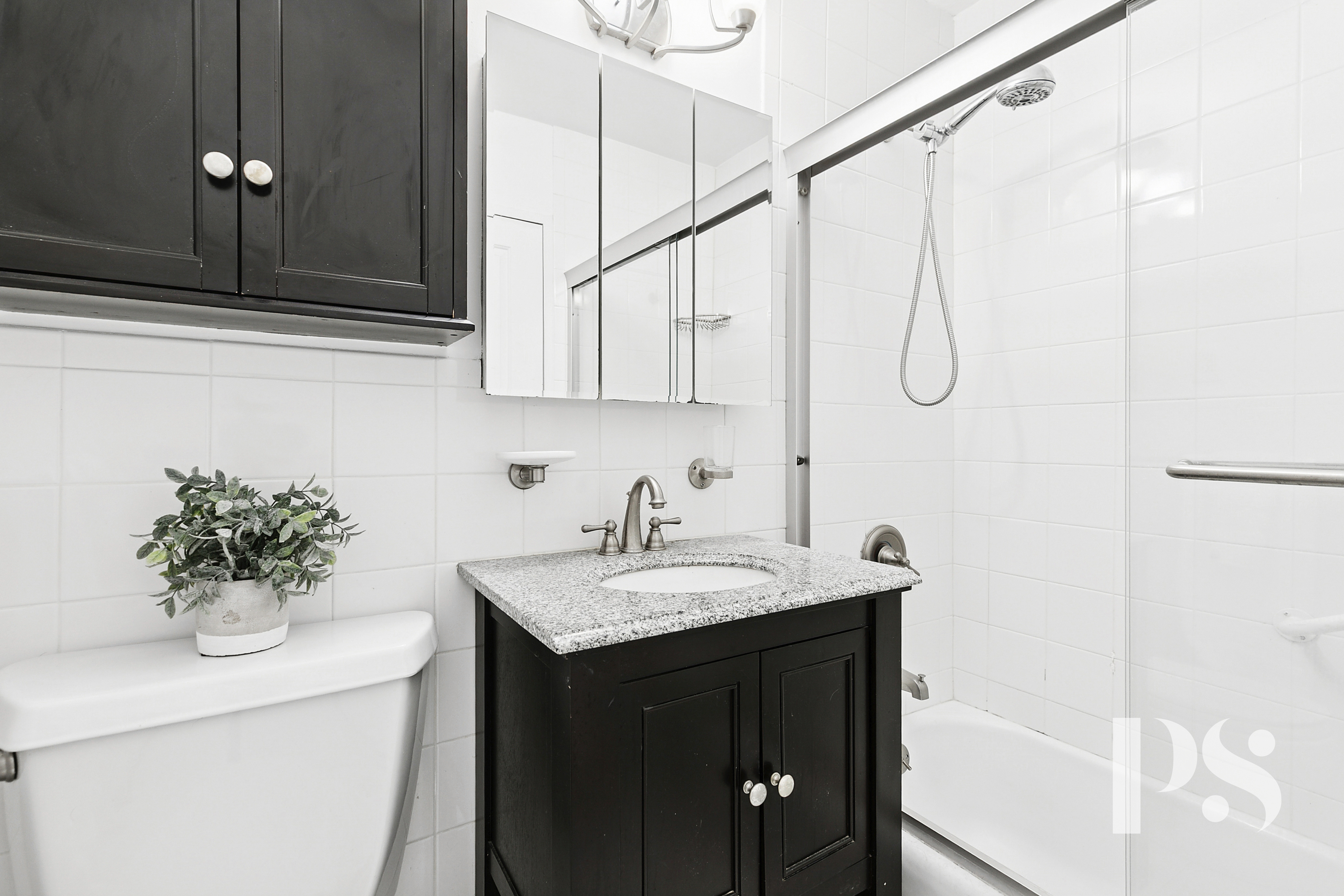 333 East 79th Street, Unit 6R Manhattan, NY 10075 - Photo 6 of 8 a bathroom with a sink and a mirror