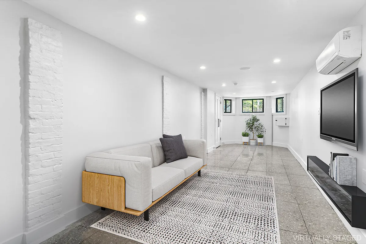 866 Bushwick Avenue, Unit 1 Brooklyn, NY 11221 - Photo 10 of 13 a living room with furniture and a flat screen tv