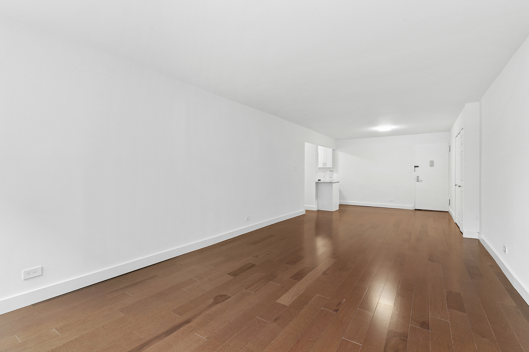 333 East 14th Street, Unit 2C Manhattan, NY 10003 - Photo 5 of 12 a view of empty room with wooden floor