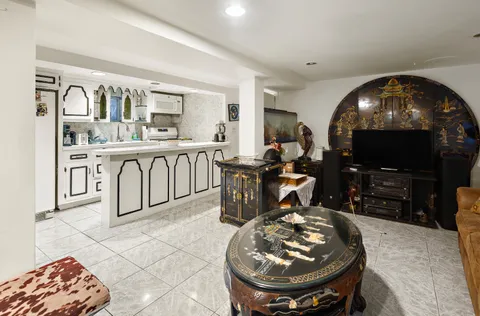 a kitchen with sink and view of living room
