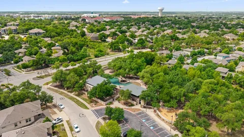 an aerial view of a house with swimming pool and garden