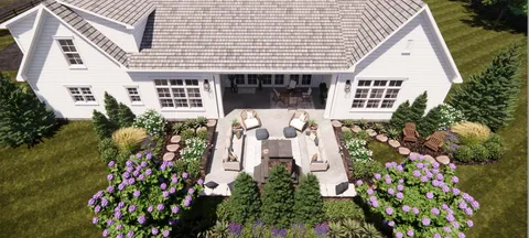 a front view of a house with lots of flowers