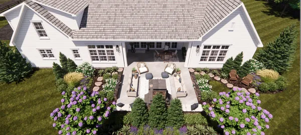 a front view of a house with lots of flowers