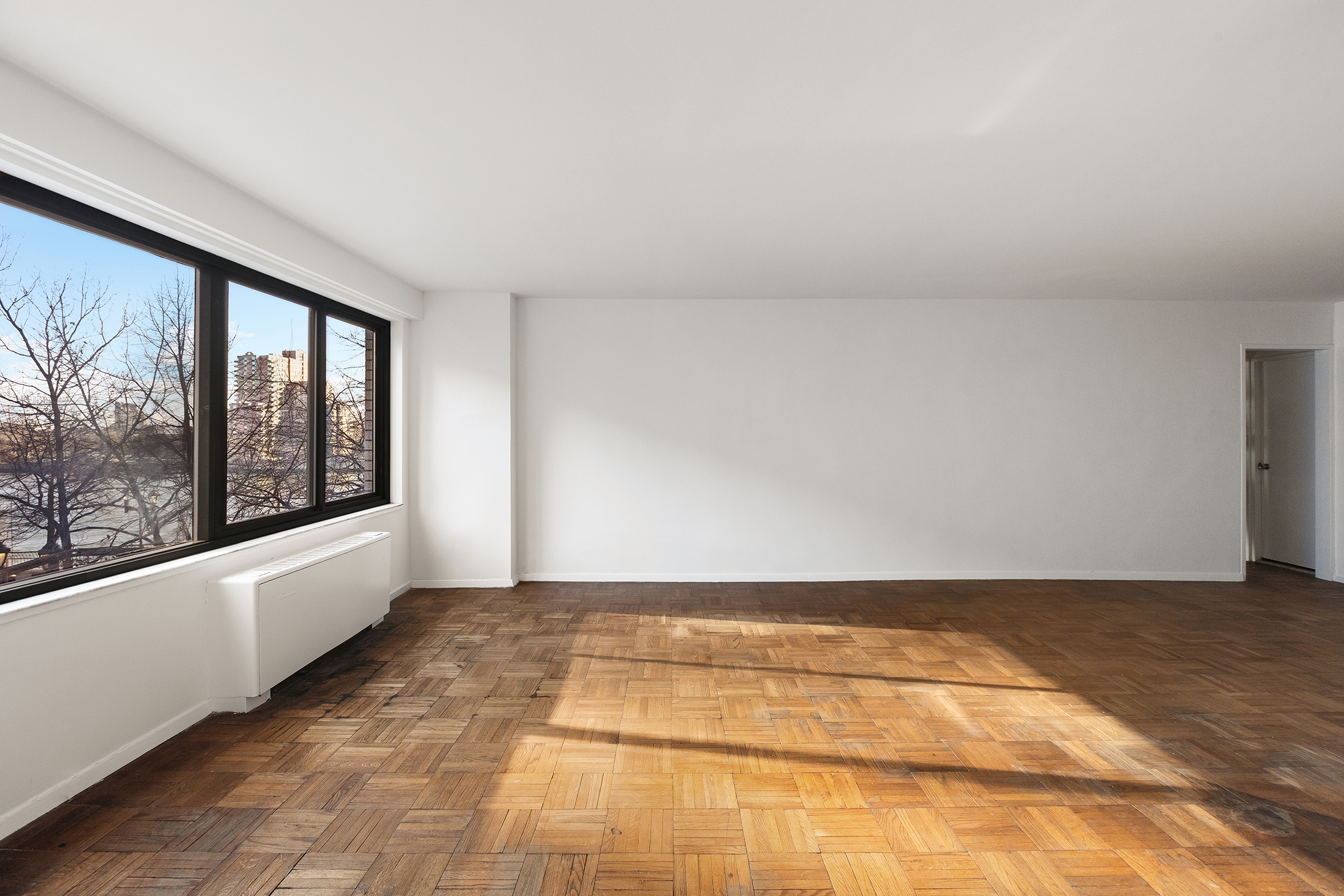 530 East 72nd Street, Unit 3C Manhattan, NY 10021 - Photo 5 of 10 a view of an empty room with a window