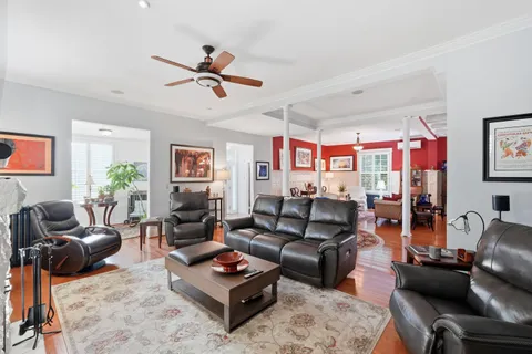 a living room with furniture a rug and a window