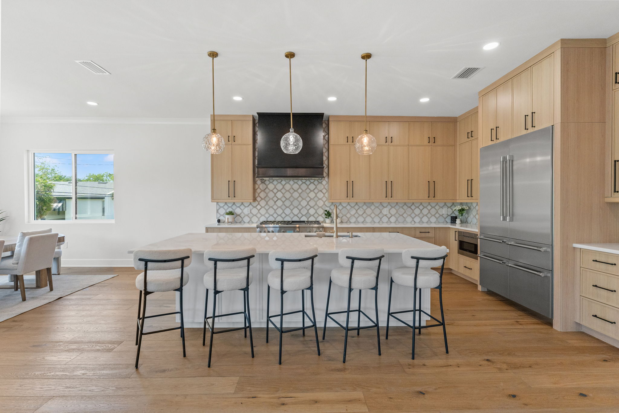 500 East Davis Boulevard Tampa, FL 33606 - Photo 8 of 36 a kitchen with stainless steel appliances granite countertop a kitchen island a stove a refrigerator a sink a dining table and chairs with wooden floor