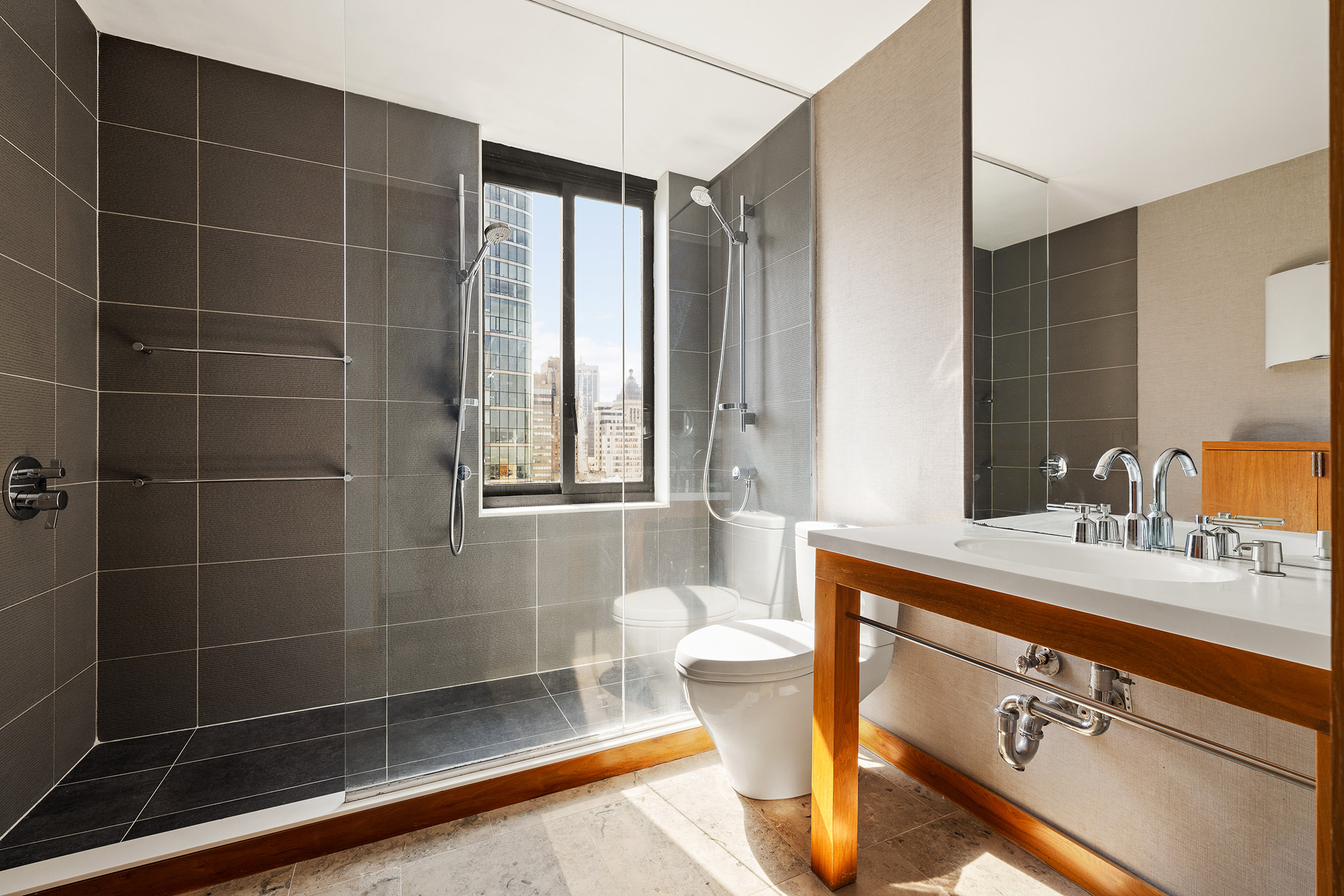 200 Rector Place, Unit 36LM Manhattan, NY 10280 - Photo 10 of 15 a bathroom with a double vanity sink mirror and shower