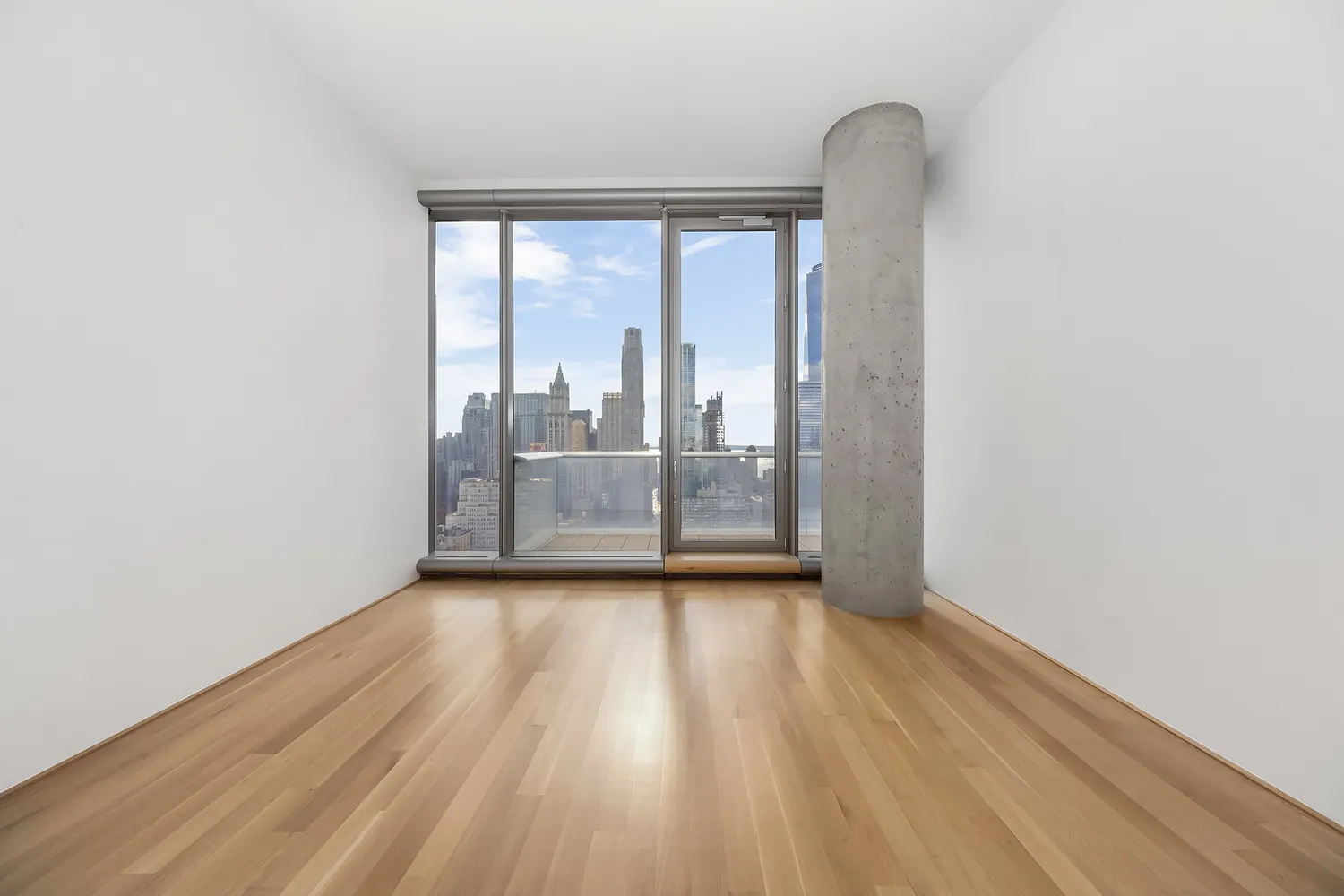 a view of a room with wooden floor and sliding glass door