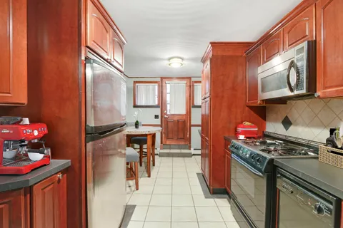 a kitchen with stainless steel appliances a stove refrigerator sink and cabinets