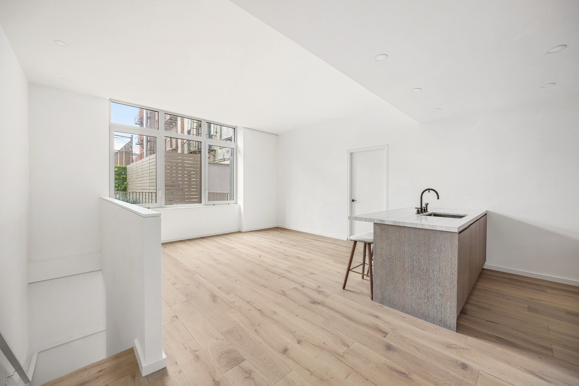 66 Clinton Street, Unit 1A Manhattan, NY 10002 - Photo 4 of 20 a workspace with wooden floor and windows