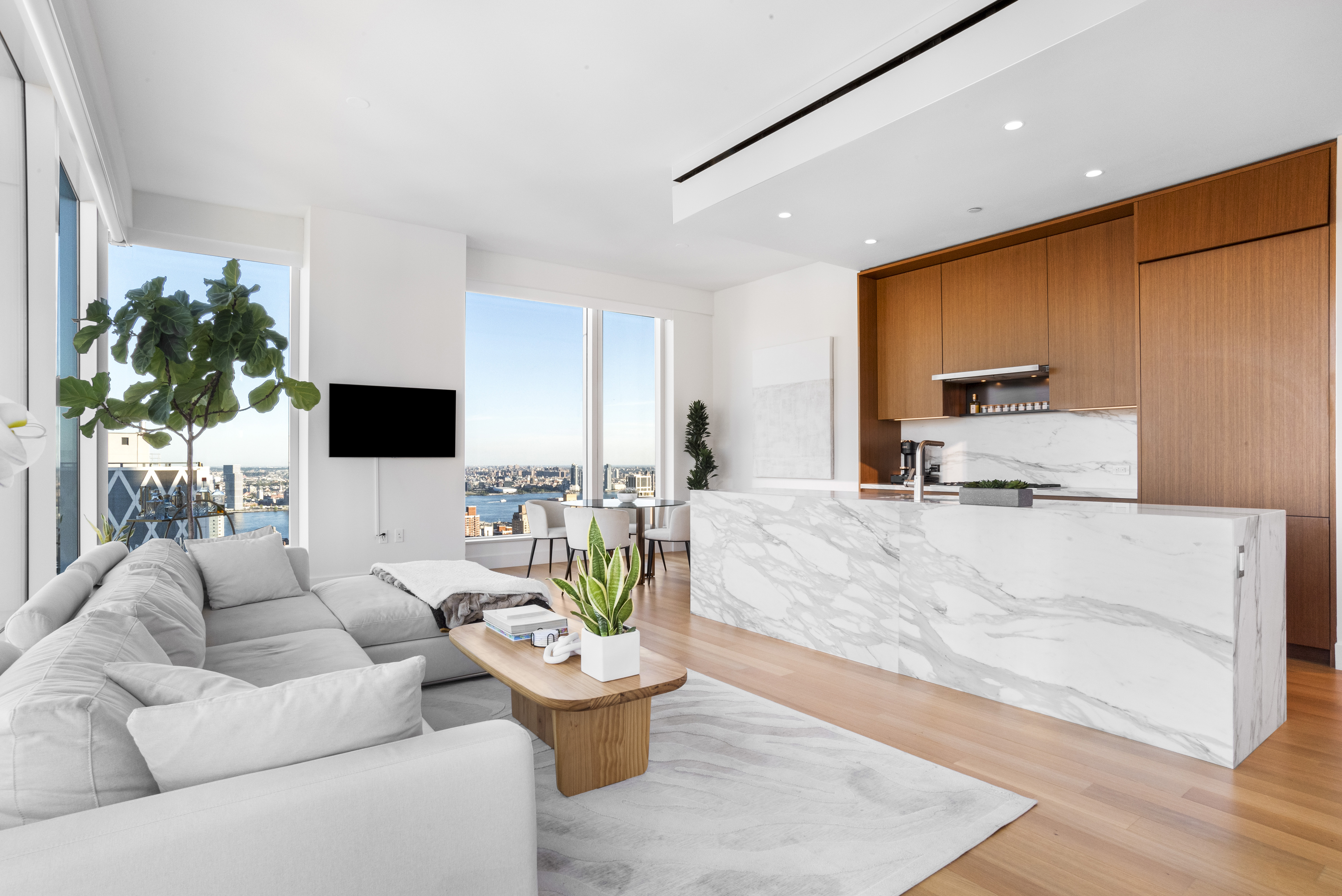 15 East 30th Street, Unit Undisclosed Manhattan, NY 10016 - Photo 3 of 23 a living room with furniture and a flat screen tv