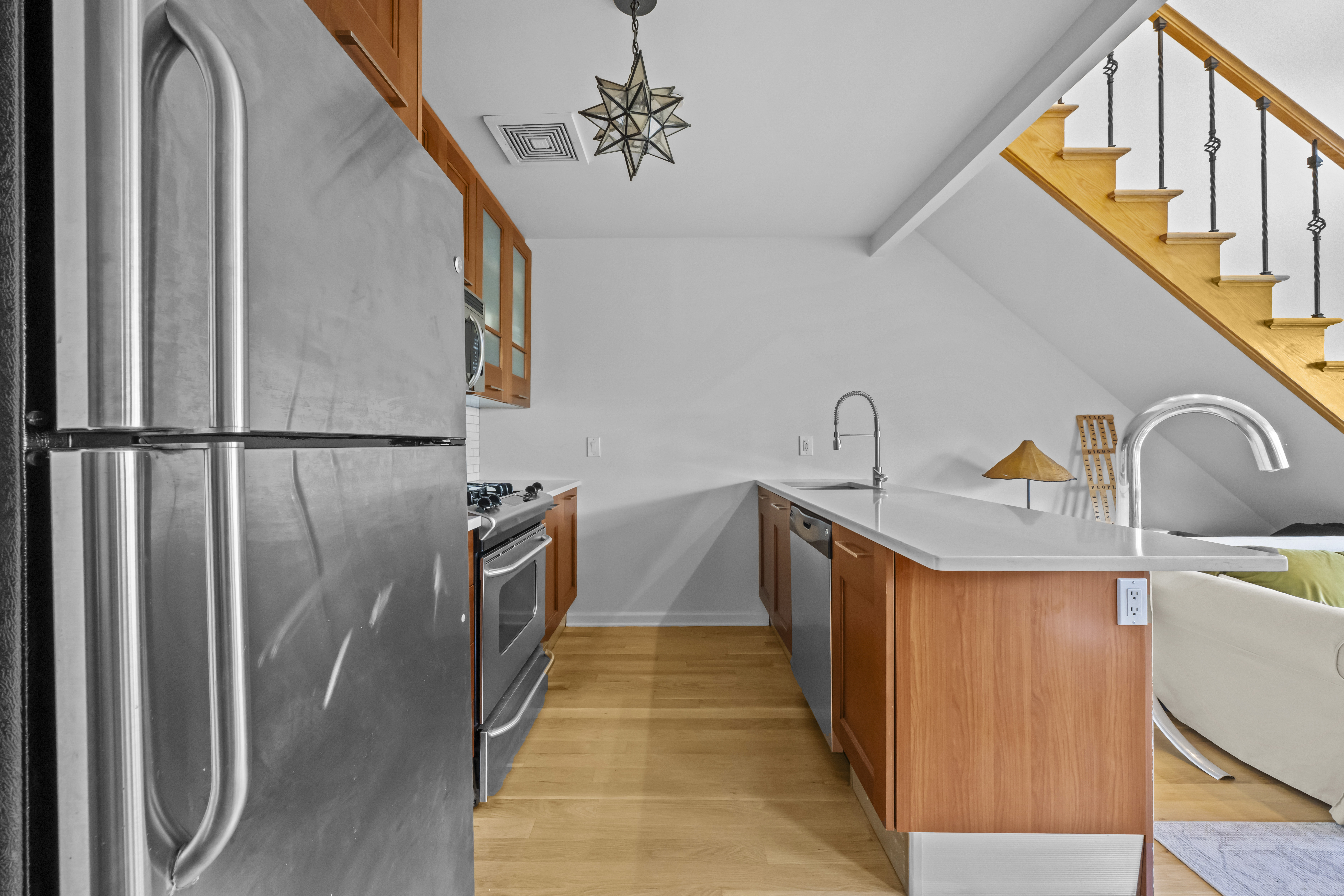 368 12th Street, Unit 5 Brooklyn, NY 11215 - Photo 5 of 11 a hallway with stainless steel appliances a sink and cabinets