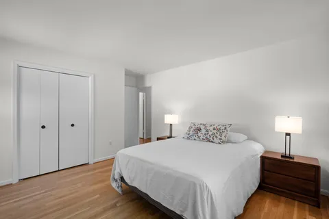 a bedroom with a bed and a lamp