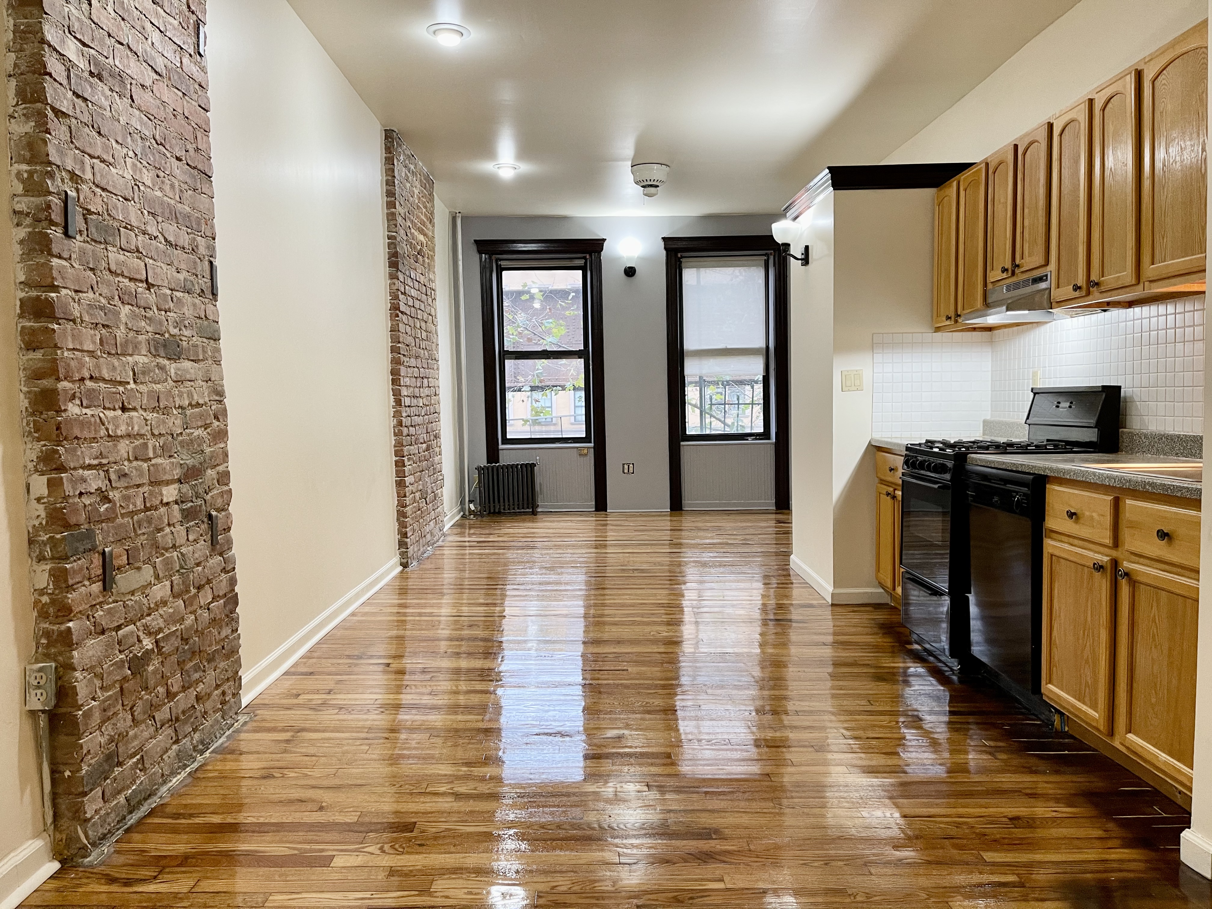 1672 Park Avenue Manhattan, NY 10035 - Photo 4 of 35 a view of a kitchen with kitchen island stainless steel appliances wooden floor and cabinets