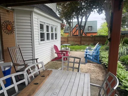 a view of a house with backyard and sitting area