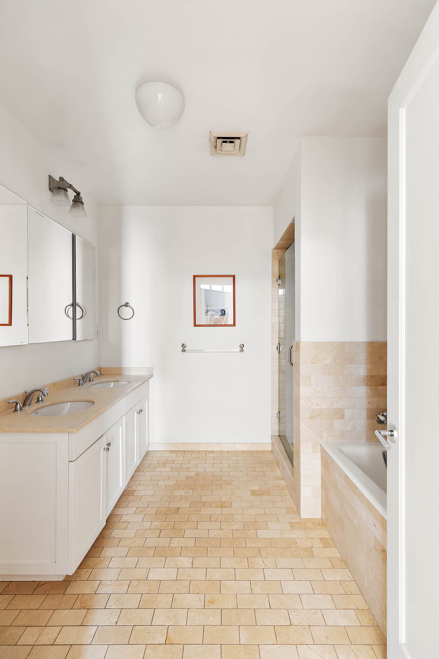 126 West 22nd Street, Unit 5N Manhattan, NY 10011 - Photo 8 of 13 a bathroom with a granite countertop sink a mirror and a bathtub