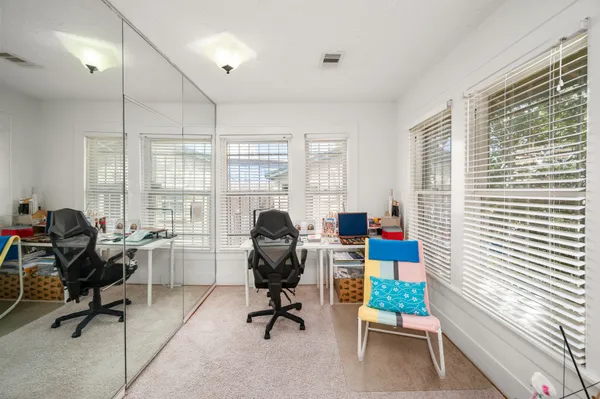 a view of a workspace with furniture and a window
