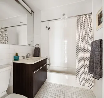 a kitchen with a sink a refrigerator and cabinets