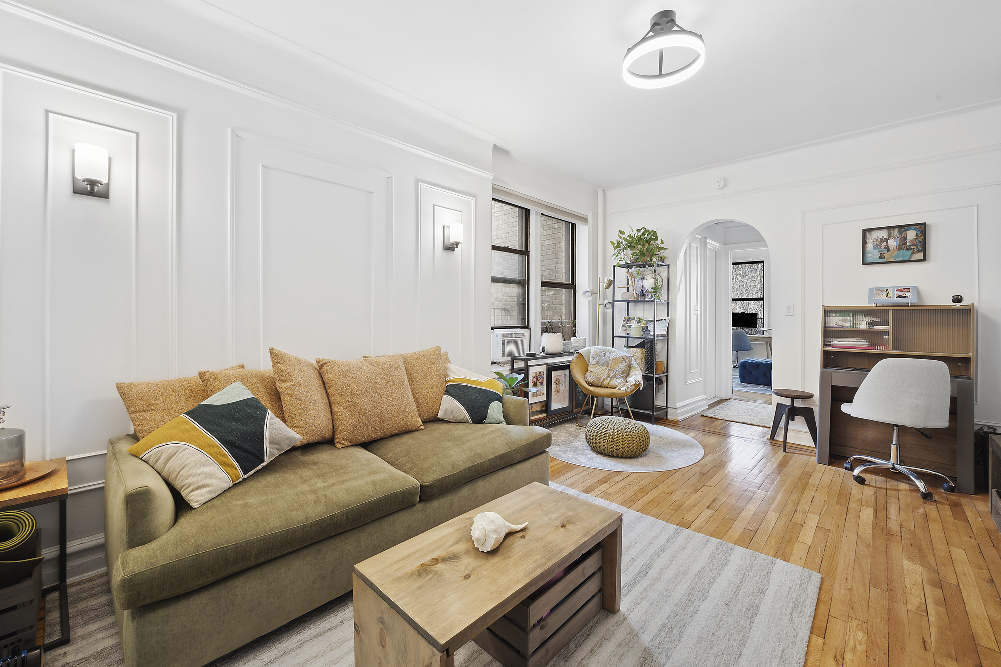 a living room with furniture and wooden floor