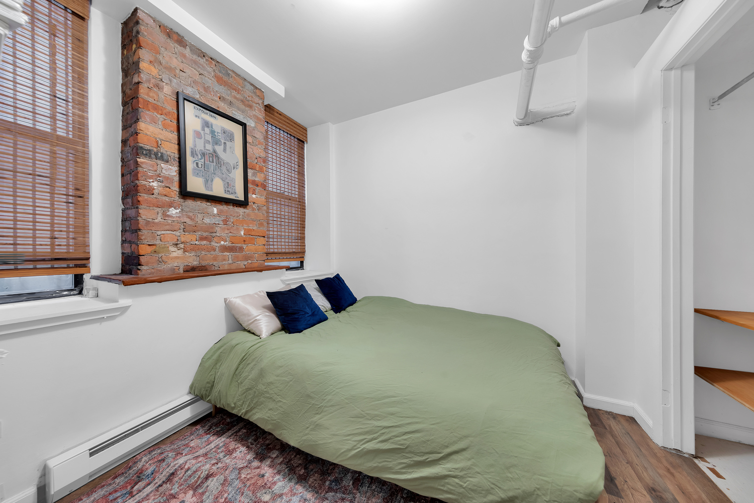 224 East 11th Street, Unit GARDEN Manhattan, NY 10003 - Photo 5 of 6 a bedroom with a bed and a window