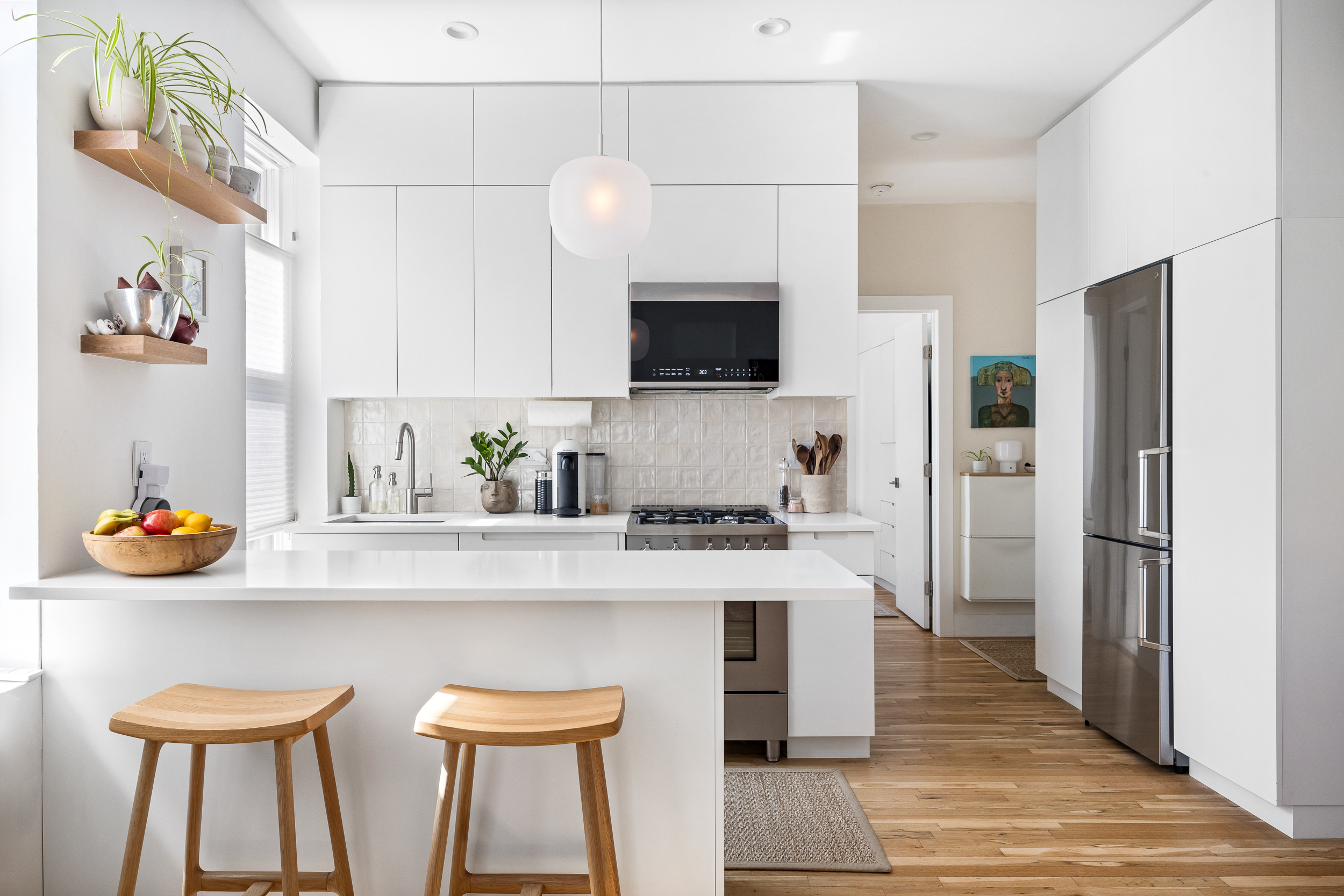 26 Butler Place, Unit 48 Brooklyn, NY 11238 - Photo 2 of 14 a kitchen with stainless steel appliances white cabinets a sink and a stove